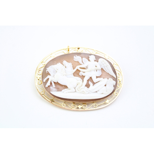 481 - A cameo brooch set in 9ct gold chain, the cameo showing Winged Victory with three horses leaving the... 