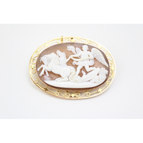 481 - A cameo brooch set in 9ct gold chain, the cameo showing Winged Victory with three horses leaving the... 