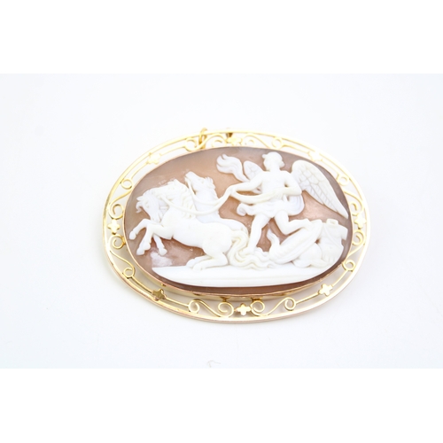 481 - A cameo brooch set in 9ct gold chain, the cameo showing Winged Victory with three horses leaving the... 