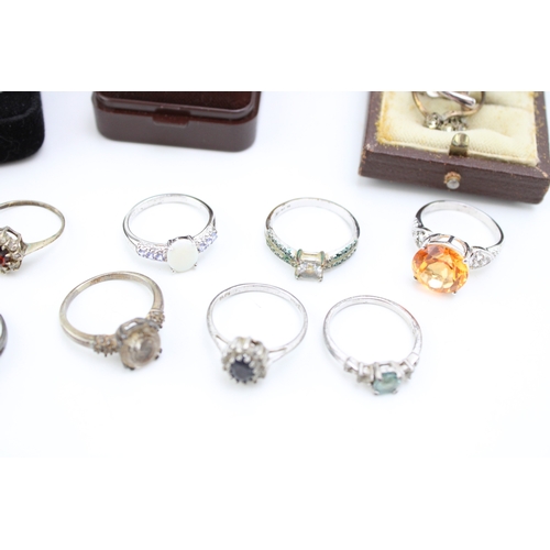 486 - A  group of ten silver dress rings, mostly set with gem stones, including opal, quartz, topaz and ot... 