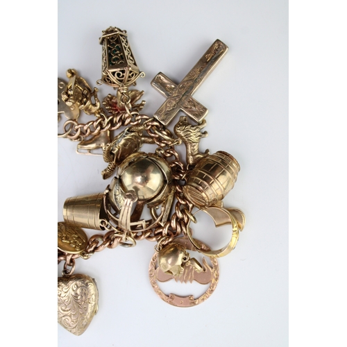 503 - A 9ct gold curb link charm bracelet with twenty seven charms, including a half sovereign, Queen Vict... 