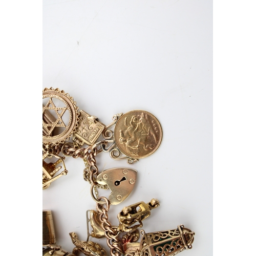 503 - A 9ct gold curb link charm bracelet with twenty seven charms, including a half sovereign, Queen Vict... 