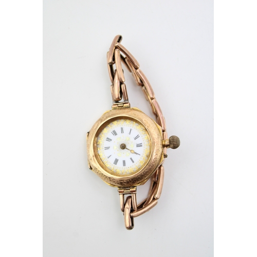 511 - A 14ct gold cased wristwatch, the enamel dial with Roman numerals and foliate detail, likely Contine... 