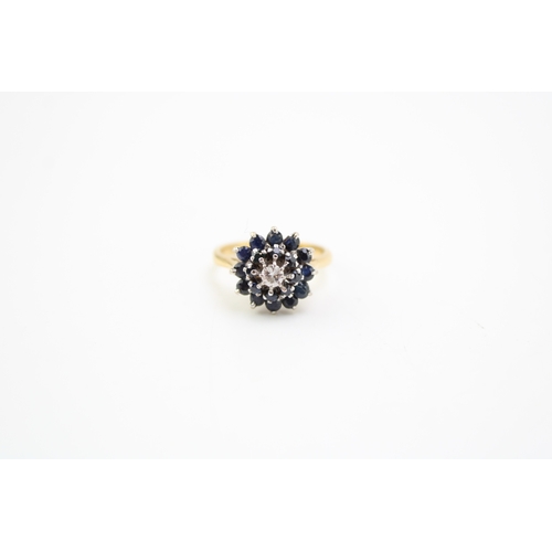 512 - An 18ct gold, sapphire and diamond cluster ring, of mid century design, set with two concentric circ... 