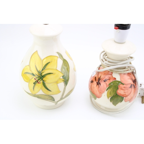 603 - A Moorcroft lamp base in the 'Bermuda Lily' pattern together with another example in the 'Hibiscus' ... 