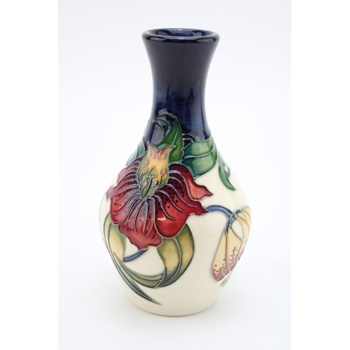 604 - Moorcroft vase in the Anna Lily design, 13.5cm tall.