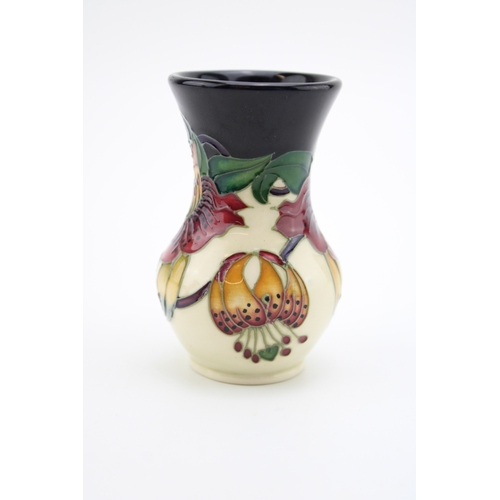 605 - Moorcroft small vase in the Anna Lily pattern, 8.5cm tall.