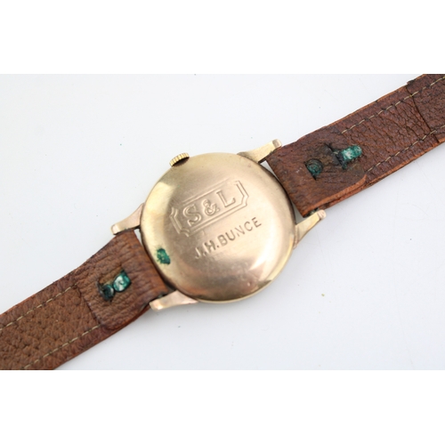 63 - Trebex 9ct gold cased gentleman's wristwatch, leather strap, 34mm wide, winds, ticks, sets and runs.