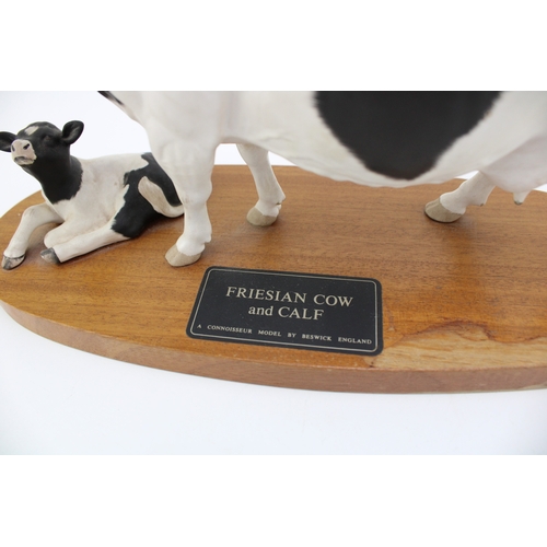 660 - Beswick Friesian Cow and Calf, connoisseur range on wooden plinth.