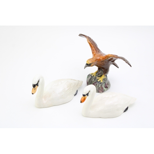 687 - Two Beswick Swans with a Beswick Eagle on Rock (3).