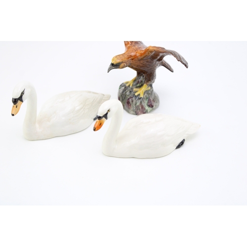 687 - Two Beswick Swans with a Beswick Eagle on Rock (3).