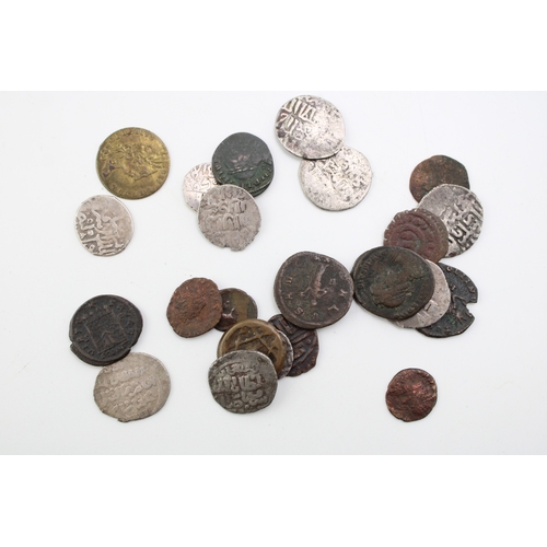 76 - A collection of hammered silver coins. Possibly of Moroccan / Islamic origin together with copper co... 