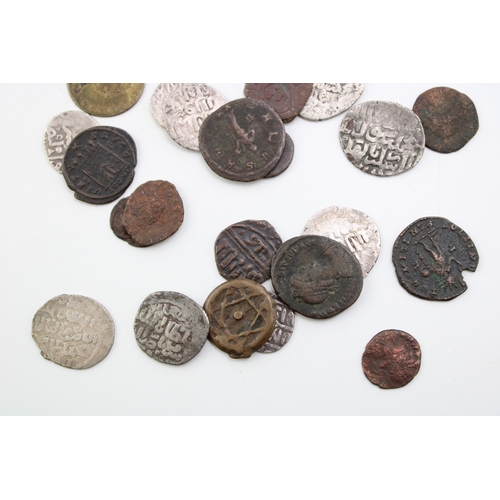 76 - A collection of hammered silver coins. Possibly of Moroccan / Islamic origin together with copper co... 