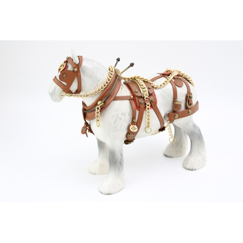 171 - A Beswick Shire horse in working harness, 21.5cm tall.