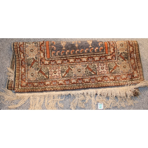 178 - A vintage hand knotted Middle Eastern carpet. 161cm x 90cm.