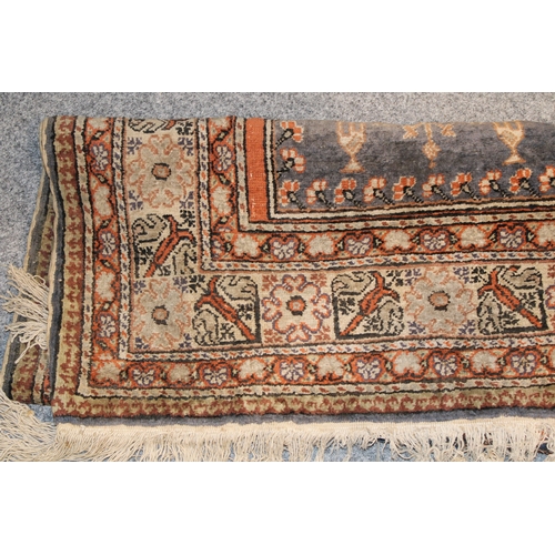 178 - A vintage hand knotted Middle Eastern carpet. 161cm x 90cm.