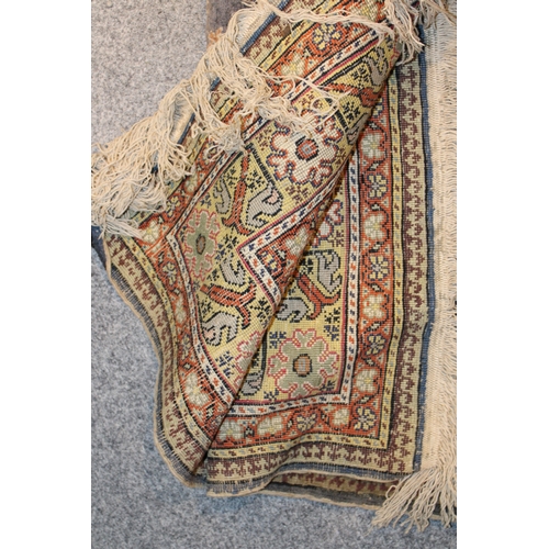 178 - A vintage hand knotted Middle Eastern carpet. 161cm x 90cm.