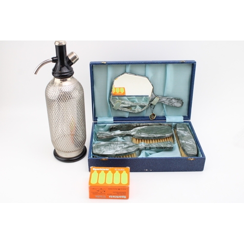 182 - A vintage Soda Siphon tother with a boxed vanity set 'Made in England'.