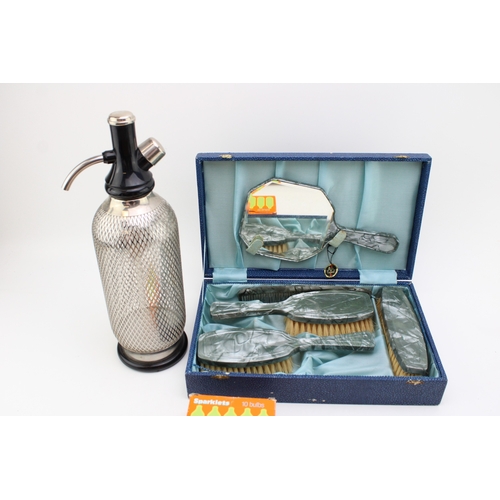 182 - A vintage Soda Siphon tother with a boxed vanity set 'Made in England'.