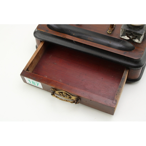 187 - An antique desk inkwell set with drawer, width 25cm.