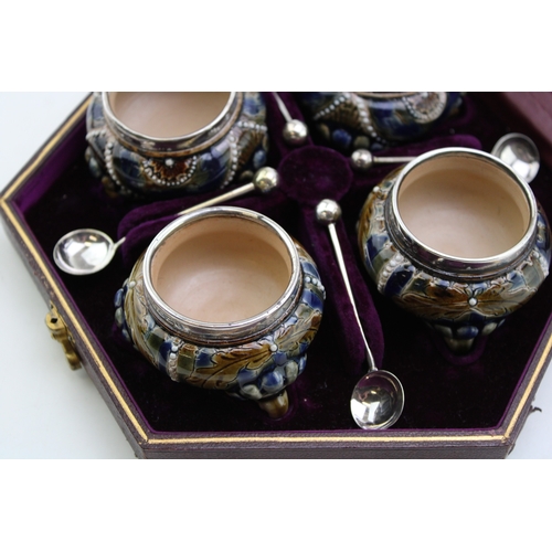 195 - Four Doulton Lambeth stoneware salt cellars, in fitted velvet-lined presentation case, silver rims, ... 