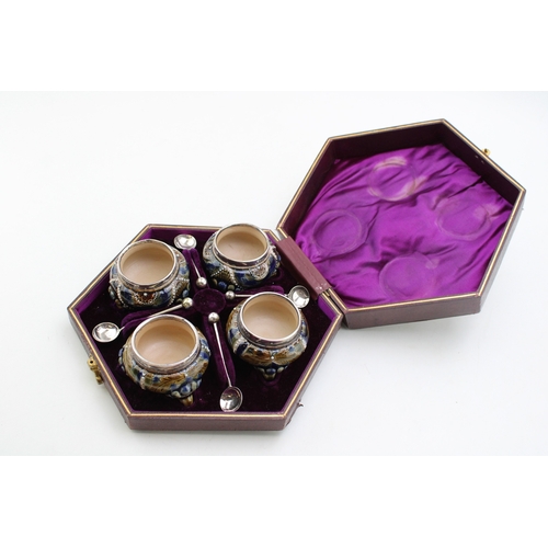 195 - Four Doulton Lambeth stoneware salt cellars, in fitted velvet-lined presentation case, silver rims, ... 