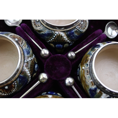 195 - Four Doulton Lambeth stoneware salt cellars, in fitted velvet-lined presentation case, silver rims, ... 
