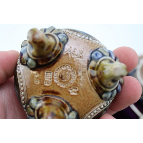 195 - Four Doulton Lambeth stoneware salt cellars, in fitted velvet-lined presentation case, silver rims, ... 
