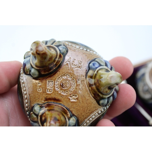195 - Four Doulton Lambeth stoneware salt cellars, in fitted velvet-lined presentation case, silver rims, ... 