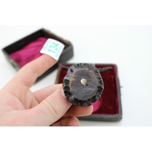 134 - A pair of cased 19th century American horn knife rests, white metal with carved horn in the form of ... 