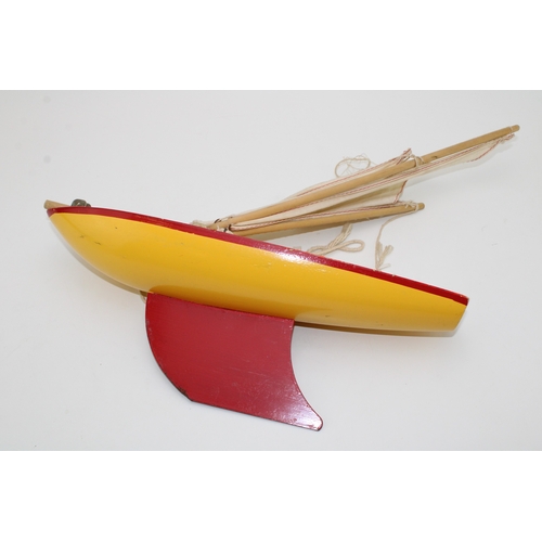 164 - Star Yacht, Birkenhead, pond yacht in yellow and red colour-way, 36cm wide, 47cm tall.