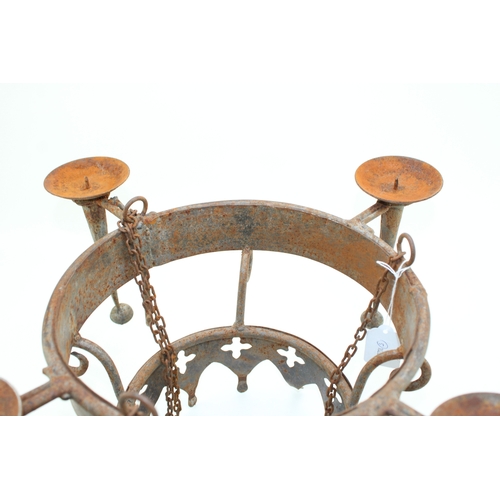 22 - Gothic style iron candleabra with holders for four candles, 51cm wide, 25cm tall.