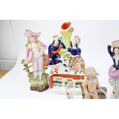 33 - A collection of continental and Staffordshire ceramics to include a pair of miniature figures, other... 