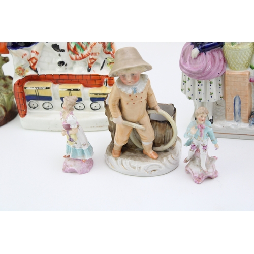33 - A collection of continental and Staffordshire ceramics to include a pair of miniature figures, other... 