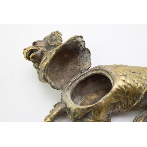 11 - A late c19th Victorian brass inkwell in the form of a spaniel dog with glass eyes with hinged head