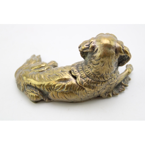 11 - A late c19th Victorian brass inkwell in the form of a spaniel dog with glass eyes with hinged head