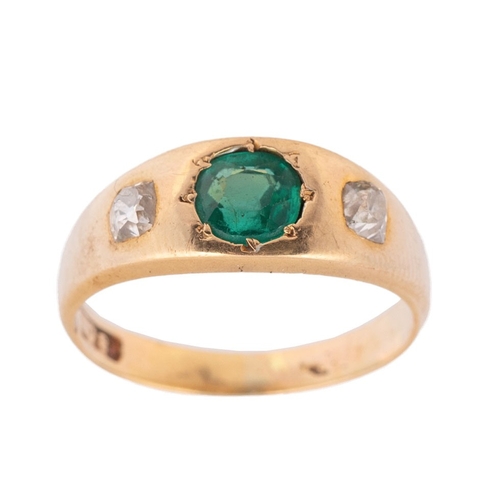 An 18ct gold, diamond and emerald set ring, the central inset emerald of approximately 6.1mm diameter, with cushion cut diamond to each shoulder of approximately 3.5 by 3.5mm, ring size M/N, total weight 5.2g.