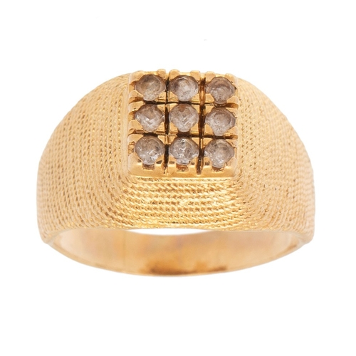 338 - A gold ring, of curved textured pyramidal form, set with square panel of nine small cubic zirconia, ... 