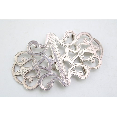 150 - A silver nurse's buckle of scrolling strapwork form with engraved detail, William Clarke & Son, Ches... 