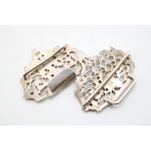 151 - A Victorian silver nurse's buckle of scrolling form with two putti either side, Henry Matthews, Birm... 