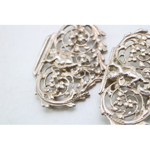 151 - A Victorian silver nurse's buckle of scrolling form with two putti either side, Henry Matthews, Birm... 