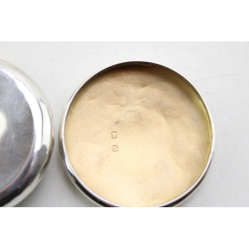 152 - A Victorian silver pill box of circular form, with scrolling acanthus leaf border to the lid and gil... 