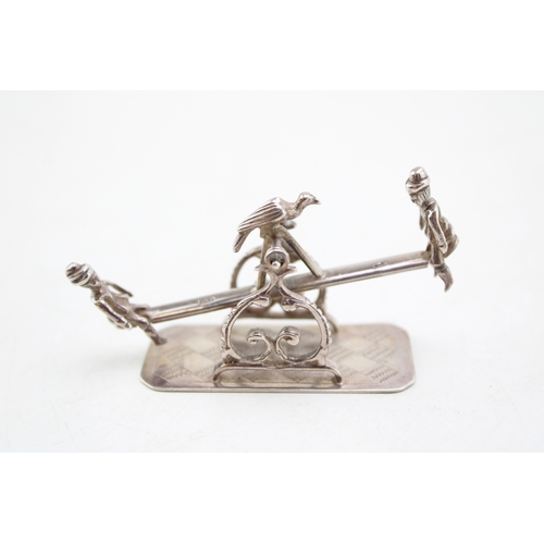157 - A turn of the 20th century Dutch silver model of a see-saw, fully balanced and movable with a child ... 