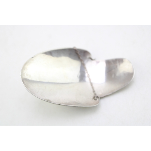 165 - A silver wine bottle drip catcher, likely for claret, of simple curved form with fine chain, Hammond... 