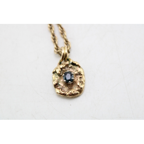 185 - A 9ct gold and sapphire brutalist pendant of organic nugget flower form with pair of leaves to the t... 