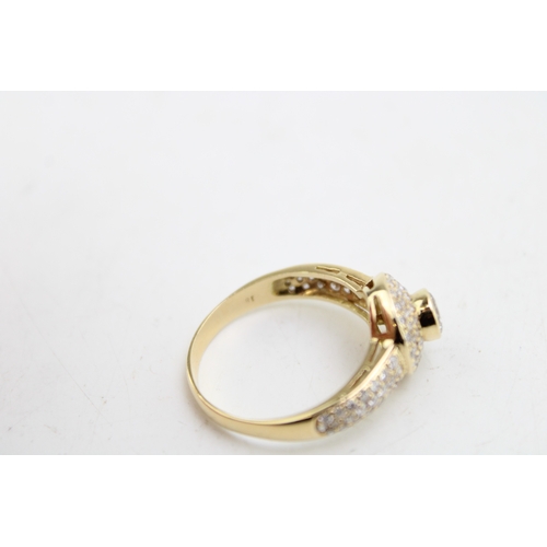 186 - An 18ct gold and diamond halo ring, the central diamond with three rows of diamond brilliants surrou... 