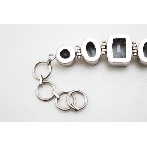 203 - A vintage silver lady's bracelet, set with blue coloured stones, 20cm long.