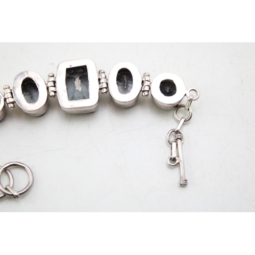 203 - A vintage silver lady's bracelet, set with blue coloured stones, 20cm long.