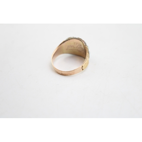 235 - A Victorian 15ct gold, garnet and seed pearl mourning ring, the panel set with a cabochon garnet sur... 