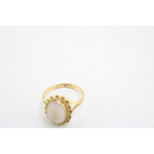 241 - 18ct gold ring set with cabochon opal, ring size N / O, 4.1g.